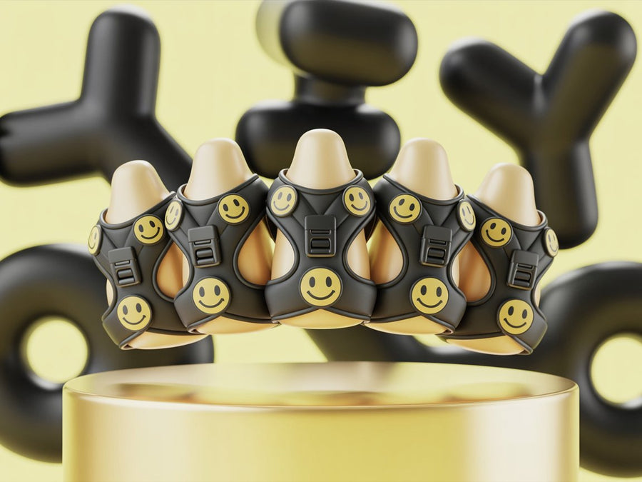 Stylish black dog harnesses with yellow smiley face design on display.