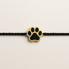 Rakhi Combo for Dogs – black and gold paw-shaped rakhi on braided black thread, part of the PawTaaka Bandana + Rakhi Gift ₹499 set.