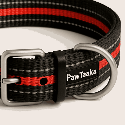 Close-up of PawTaaka Flex Mode Reflective Dog Collar – Red & Black showing brand label, sturdy buckle, and reflective red stripe detail.