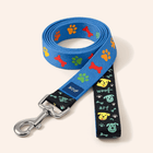 PawTaaka PlayPaws Dog Leash in blue with colorful paw and bone prints, featuring a sturdy metal clip and playful black handle design.