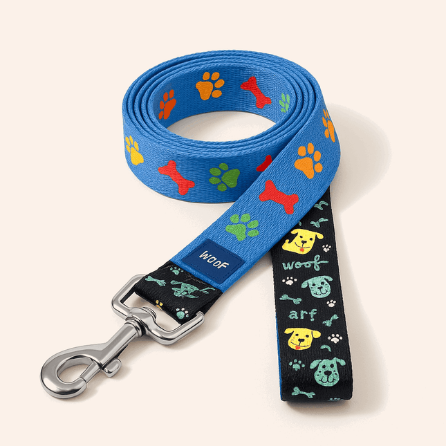 PawTaaka PlayPaws Dog Leash in blue with colorful paw and bone prints, featuring a sturdy metal clip and playful black handle design.