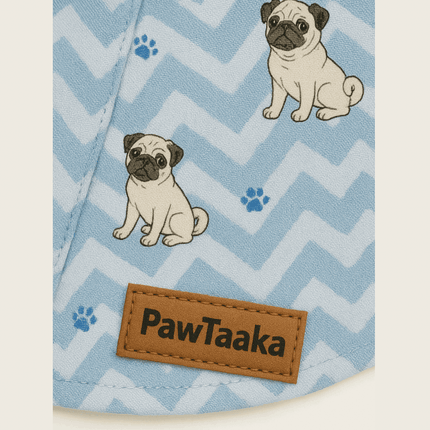 Close-up of PawTaaka logo patch on ZigZag Dog Shirt – Icy Blue Paws, showing pug illustrations and blue zigzag pattern in pet fashion detail.