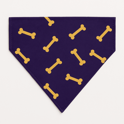 Flat lay of PawTaaka Bone Vibes Dog Bandana in navy with yellow bone print, showcasing its vibrant design and neat stitching.