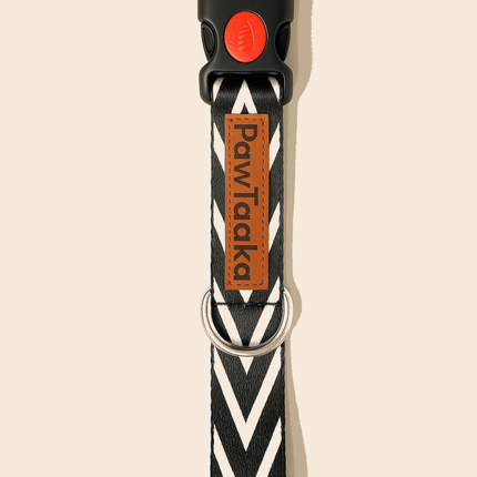 Black dog collar with chevron print and red safety buckle, featuring PawTaaka logo tag. Adjustable and durable for everyday pet use.